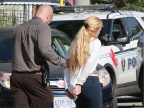 A woman is arrested by a Windsor police officer in the 3500 block of Sandwich Street on Monday, Oct. 17, 2016, in relation to a child abduction.