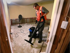 Jesse Martin from the Christian Aid Ministries organization is shown on Tuesday, Oct. 4, 2016, helping an east Windsor couple clean the flood damage in their basement.