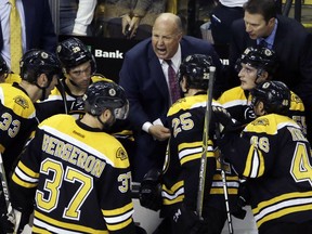 Boston Bruins head coach Claude Julien instructs his team during a timeout in the third period against the New Jersey Devils, Thursday, Oct. 20, 2016, in Boston. The Bruins won 2-1.