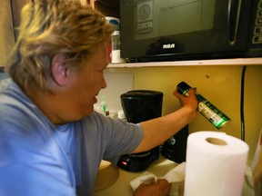 Beverly Dupuis sprays a cockroach in her apartment at 920 Ouellette Ave., on Oct. 12, 2016 in Windsor.