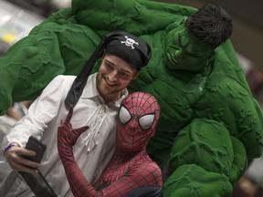 Jeremy Bensette, dressed as a pirate, takes a selfie with the Hulk and Spiderman at Windsor ComiCon at Caesars Windsor, Saturday, Oct. 15, 2016.