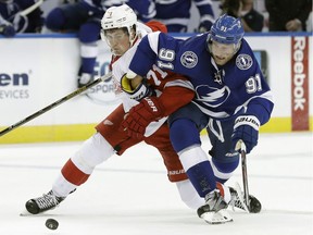 Detroit Red Wings centre Dylan Larkin takes down Tampa Bay's Steven Stamkos Thursday, Oct. 13, 2016, in Tampa, Fla. Larkin was penalized on the play. The Lightning won 6-4.
