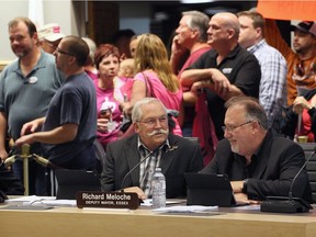 Essex Mayor Ron McDermott, left, and Deputy Mayor Richard Meloche converse as visitors pile into county council meeting at Civic Centre on Oct. 19, 2016.