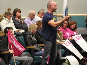 About 40 striking Essex County librarians and supporters including Windsor firefighter Wayne Currie, centre, attended the Essex County Library board meeting at Essex Civic Centre, October 26, 2016.