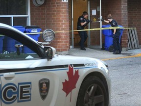 Windsor police forensic officers gather evidence at the scene of a violent kidnapping at an apartment building on Mill Street on Oct. 19, 2016.