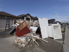 Flood damaged items rest in a pile, Sunday, Oct. 2, 2016, after the d'Entremont's family basement flooded on the 2900 block of McRobbie Crescent.