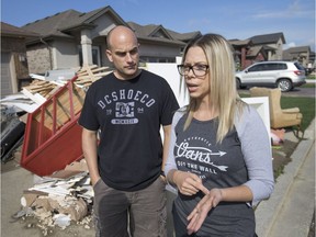 Genevieve and Trevor d'Entremont, new residents to Windsor, are pictured next to their flood-damaged items from their basement on the 2900 block of McRobbie Cres. on Oct. 2, 2016.