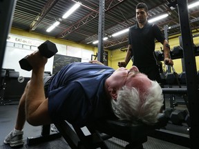 Larry McRae works out with his trainer , Paul McCrary at King Performance Systems.   McRae suffered a broken neck and was told he'd never walk again. But he's not only walking again, he's able to run.