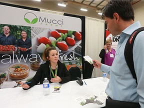 Kerri O'Neil a recruiter with Mucci Farms speaks with job seeker Giovanni Higuera during the Job Day event at the WFCU Centre in Windsor on Friday, Oct. 14, 2016.