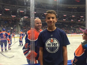 LaSalle's Zack Kassian of the Edmonton Oilers, left, photobombs a young fan prior to a game against the Vancouver Canucks on Oct. 8, 2016.