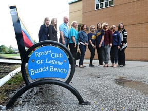 Members of the Rotary Club of LaSalle, LaSalle Public School students, staff and parents unveil the Buddy Bench initiative on Sept. 30, 2016.