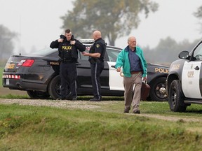 Coroner Dr. Emil Jarecsni leaves the scene as OPP officers investigate a fatal lawn mower accident on 1100 block of Mersea Road 7 near Leamington on October 18, 2016.