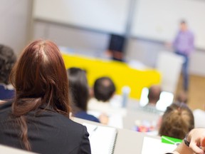 A speaker gives a presentation in a lecture hall at university.