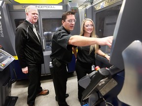 A media conference was held at Cavalier Tool & Mold in Windsor, ON. on Thursday, October 13, 2016 to unveil a new pilot project to help human resources graduates gain employment in the industrial sector. Robert Chittim, (L) chair of St. Clair College's school of skilled trades, Brian Bendig, president of Cavalier Tool and Jena Reid, a newly hired human resources employee at the business check out a graphite mill at the business.