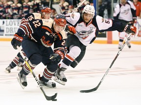 Oshawa Generals' Anthony Cirelli speeds past Windsor Spitfires' Jalen Chatfield during the first period of their OHL game at the General Motors Centre in Oshawa on Oct. 2, 2016.