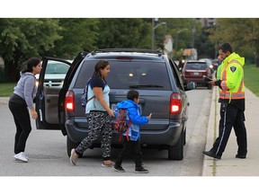 WINDSOR, ON. SEPTEMBER 28, 2016.  A City of Windsor by-law officer gets set to hand out a parking ticket in front of St. John Vianney Catholic on Wednesday, Sept. 28. 2016, where another parking ticket blitz was being held. (DAN JANISSE/The Windsor Star)