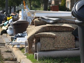 Flood-related garbage awaits pick-up from the curb at residences in the East Riverside area of Windsor on Oct. 6, 2016.