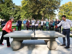 Dianne Moore, left, and Windsor city councillor Fred Francis try out the new concrete ping pong table at the Kiwanis Park in Windsor on Thursday, Oct. 6, 2016. The Moore family donated the $5,000 table to the east side park.