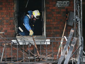 An investigator with the Ontario Fire Marshal's Office examines 227 Rankin Ave. on Oct. 27, 2016,. Andrew Kraayenbrink, 19, a University of Windsor student, died in a fire at the house.