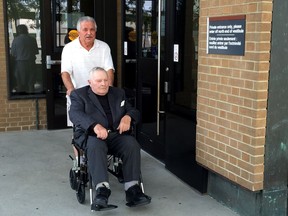 Richard James Massen, seated in the wheelchair, is assisted as he leaves Superior Court in Windsor on Oct. 6, 2016.