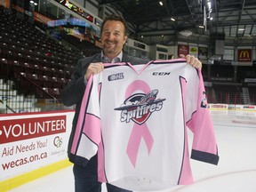 Chris Moore, group general manager of G&K Services Canada, holds up a pink jersey that the Windsor Spitfires will be wearing during their ‘Stick it to Cancer’ fundraiser against the Sault Ste. Marie Greyhounds Oct. 27