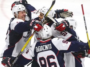 The Windsor Spitfires celebrate Jalen Chatfield's overtime goal against the London Knights on Oct. 9, 2016 at the WFCU Centre.