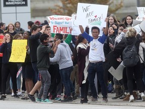 Students at St. Joseph's Catholic High School in Windsor walk out of class on Oct. 21, 2016, to support striking school staff.