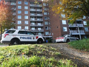 Windsor police forensic identification officers work the scene after stabbing occurred at an apartment building at 605 Mill St. in Windsor, Ont.