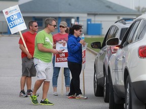 At noon on Oct. 18, 2016 there were still dozens of Villanova teachers waiting to cross the picket line as striking support staff  delayed cars from entering the high school.