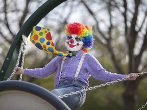 Evan Shalton, 11, has fun on the swing as he's dressed in a clown costume at the Transition to Betterness Halloween Spooktacular at Malden Park, Saturday, Oct. 29, 2016.