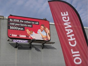 The Canadian Taxpayers Federation Alberta unveiled a billboard, outside and oil change facility, urging Alberta government to scrap the carbon tax in Calgary, Alta., Tuesday, Oct. 4, 2016.