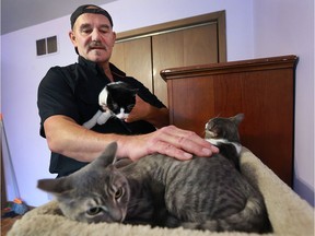 Mike Gabor, who runs the Earn Your Wings organization is shown at his Windsor home on Oct. 27, 2016, with some of the feral cats that he rescued in the city. Gabor is happy to hear that the Windsor Essex County Humane Society will start doing the same.