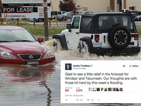 A Jeep passes a stalled out car on Advance Boulevard in Lakeshore on Thursday, September 29, 2016. Heavy rains caused flooding throughout the region.