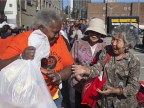 Volunteers hand out turkeys and trimmings to those in need outside the Downtown Mission, Saturday, Oct. 8, 2016.  Andy Jun, owner of ReNu Kitchen Refacing supplied over 300 turkey to hand out.