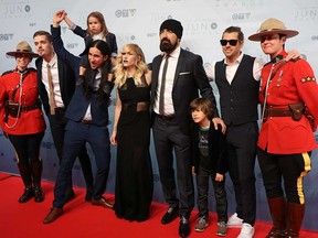 Canadian pop-rock band Walk Off the Earth pose with mounties and band members' children on the red carpet at the 2016 Juno Awards.