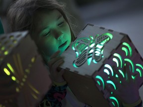 Amber McCollom, 7, checks out sound lanterns on display at W.A.V.E.S. (Windsor's Artists, Visions, Energies & Sculptures) Festival outside the Windsor International Aquatic and Training Centre, Saturday, Oct. 1, 2016.