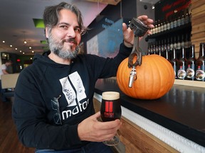 Gino Gesuale, co-owner of Motor Burger in Windsor, is shown at the Erie Street restaurant on Tuesday, Oct. 4, 2016 with a pumpkin-themed beer. It will be one of many brews featured at the Windsor Craft Beer Festival.