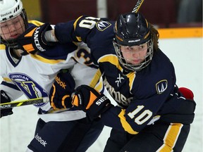 University of Windsor Lancers Krystin Lawrence, right, tangles with Laurentian Voyageurs Megan Burr in OUA women's hockey action at South Windsor Arena on Jan. 9, 2015.