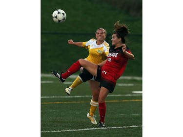 St. Clair's Cassie Nicolas, left, and Fanshawe's Emily Mitchell try to outdo each other in a fight for the ball.