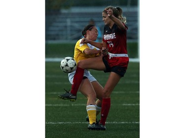 St. Clair College's Alexis Provost collides with the Fanshawe's Selena Roberts.