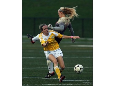 Kaitlyn Austin of St. Clair College keeps the ball from Fanshawe goaltender Ali Vlasman to score the first goal of the game.