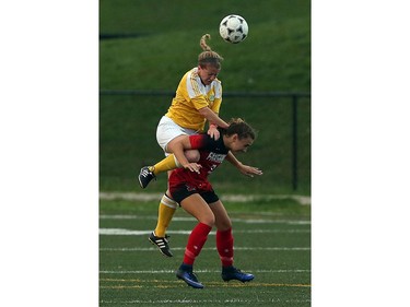 St. Clair's Marisa Stratis climbs Fanshawe's Jade Kovacevic while trying to head the ball.