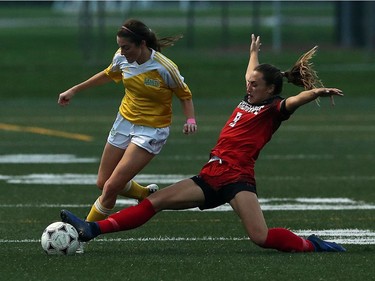 St. Clair College Saints' Alexis Provost, left, has the ball knocked away by Jade Kovacevic of the Fanshawe College Falcons at The Libro Credit Union Centre in Amherstburg on Tuesday, Oct. 18, 2016. The teams played to a 1-1 tie.