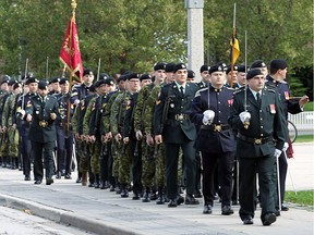 Members of the Windsor Regiment march along the streets of Windsor following a celebration to mark their 80th anniversary on Saturday, October 22, 2016.