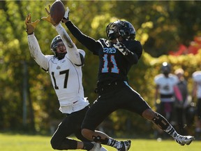 The AKO Fratmen's Tyler Storie and the Hamilton Hurricanes Zeph Fraser leap for a pass at E.J. Lajeunesse Field in Windsor on Oct. 22, 2016.