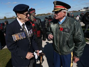 Veteran Larry Costello (left) speaks with U.S. Medal of Honour Recipient Lt. Col. Charles Kettles before a wreath laying service at the North Wall Vietnam Veterans Memorial in Windsor on Saturday, October 22, 2016.
