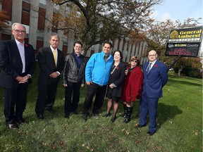 LaSalle Mayor Ken Antaya, left, Todd Awender, Amherstburg Mayor Aldo DiCarlo, John Miceli, Erin Kelly, Connie Buckler and Ron LeClair are shown in front of General Amherst high school in Amherstburg on Oct. 31, 2016.