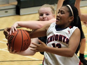 Holy Names Jade Samping, right, tries to protect the ball from Belle River's Sidney Lavin at Belle River District High School on Wednesday, October 4, 2016.