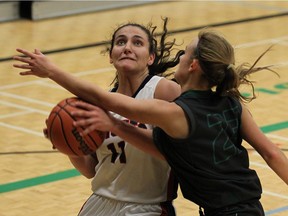 Holy Names' Khuloud Ahmad, left, runs into Belle River's Claire Lazarus at Belle River District High School on Wednesday, October 4, 2016.