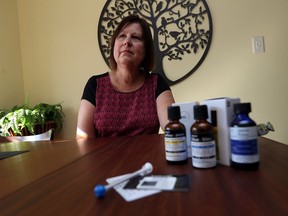 Jan Rieveley is photographed with some of the medical marijuana products she is using for pain at her home in Windsor on Oct. 7, 2016.